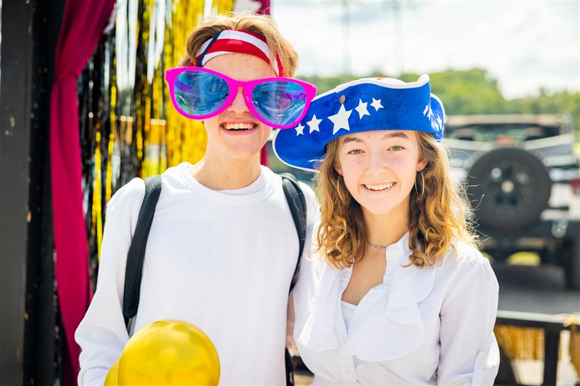 Two students smile